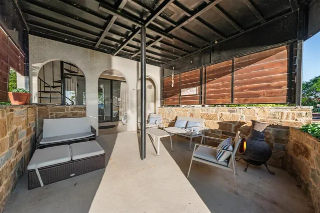 a living room with lots of furniture and a large window