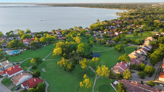 a view of a lake with a flower garden