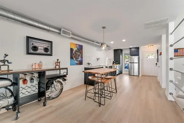 a view of a a dining room with furniture window and wooden floor