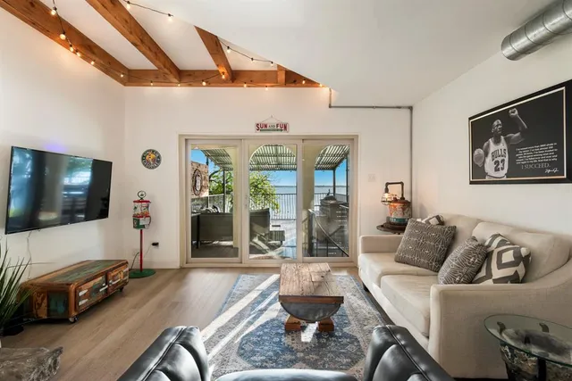 a living room with furniture and a flat screen tv