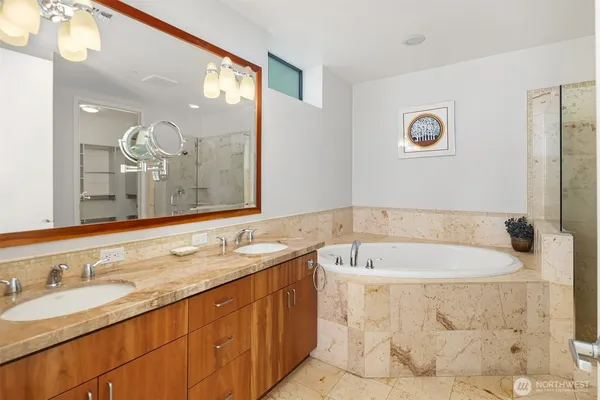 a bathroom with a bathtub sink and mirror