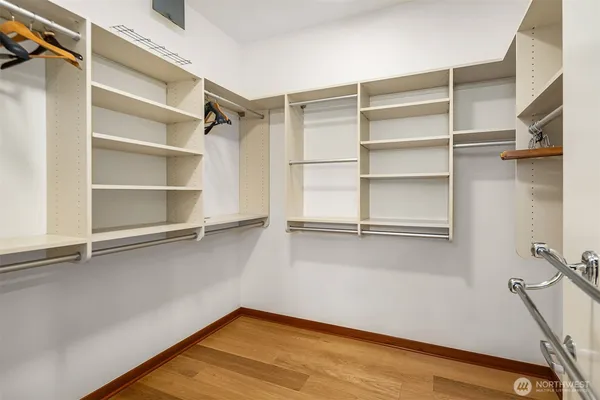 a view of walk in closet with empty racks