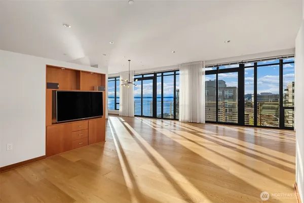 a view of an empty room with a fireplace and a window