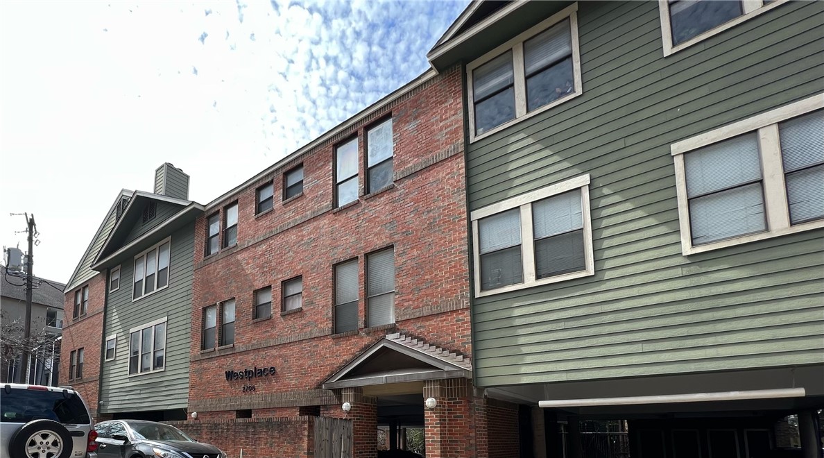 a front view of a building with many windows