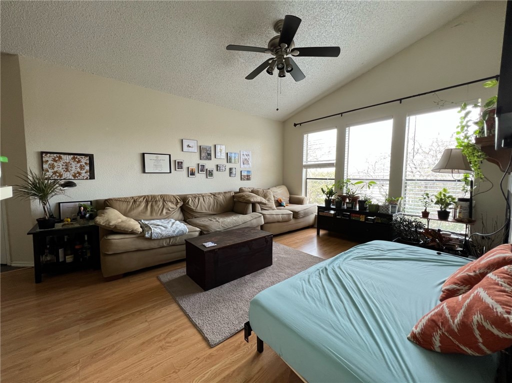 2706 Salado Street, Unit 302 Austin, TX 78705 - Photo 3 of 10 a living room with furniture ceiling fan and a large window