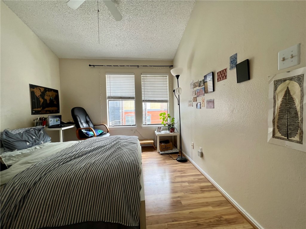 2706 Salado Street, Unit 302 Austin, TX 78705 - Photo 5 of 10 a bed room with a bed and a chair