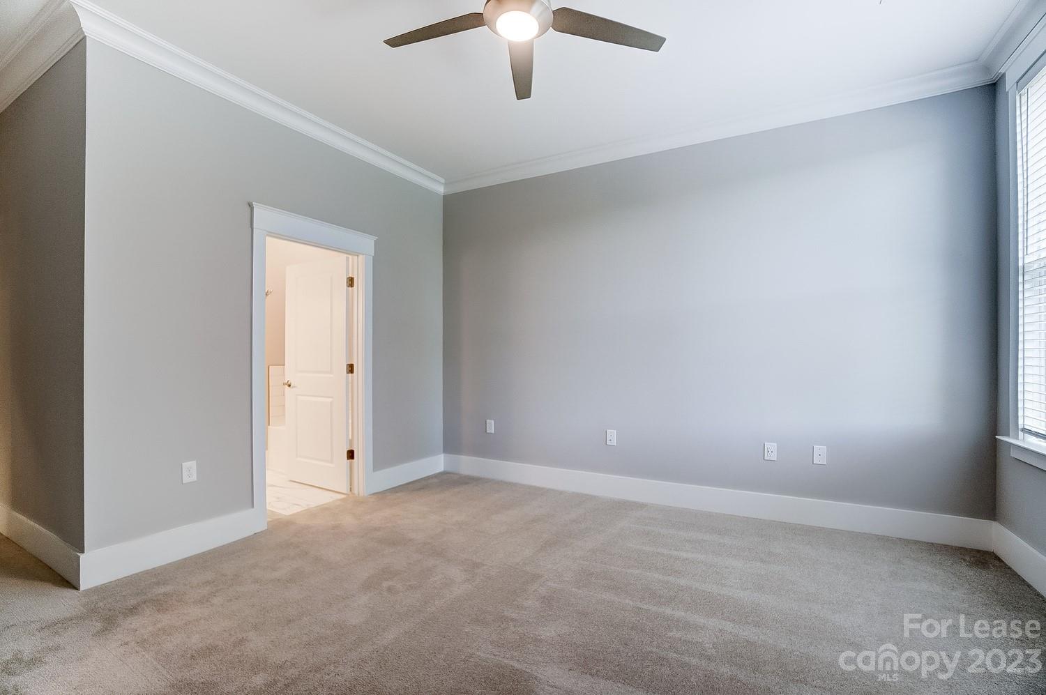 830 Providence Road, Unit 104 Charlotte, NC 28207 - Photo 11 of 21 a view of an empty room and chandelier fan