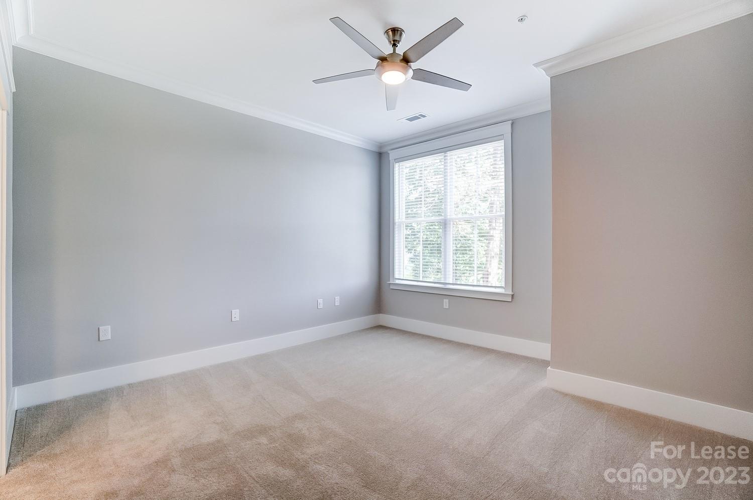 830 Providence Road, Unit 104 Charlotte, NC 28207 - Photo 13 of 21 an empty room with a window and a fan