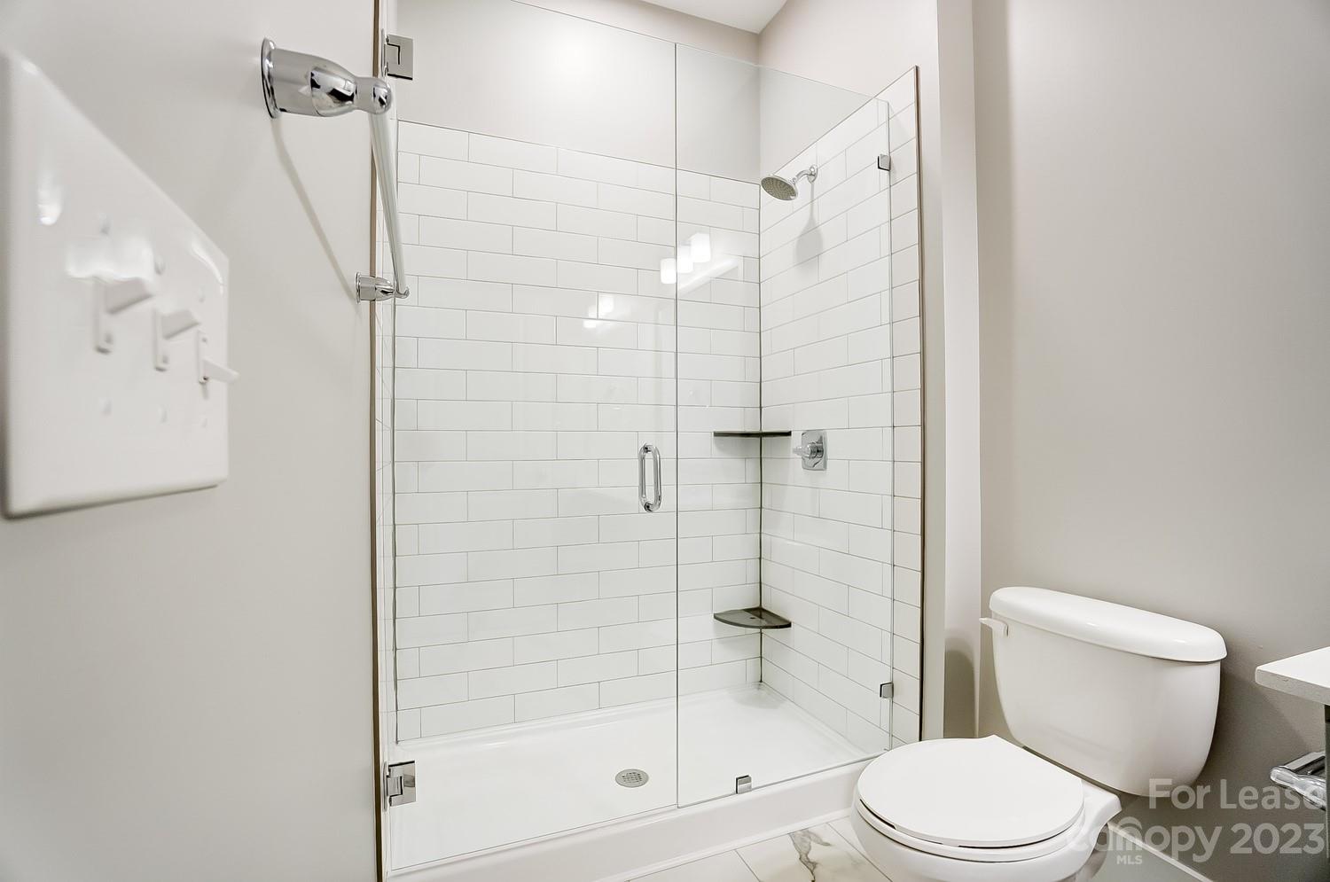 830 Providence Road, Unit 104 Charlotte, NC 28207 - Photo 16 of 21 a white toilet next to a bathroom