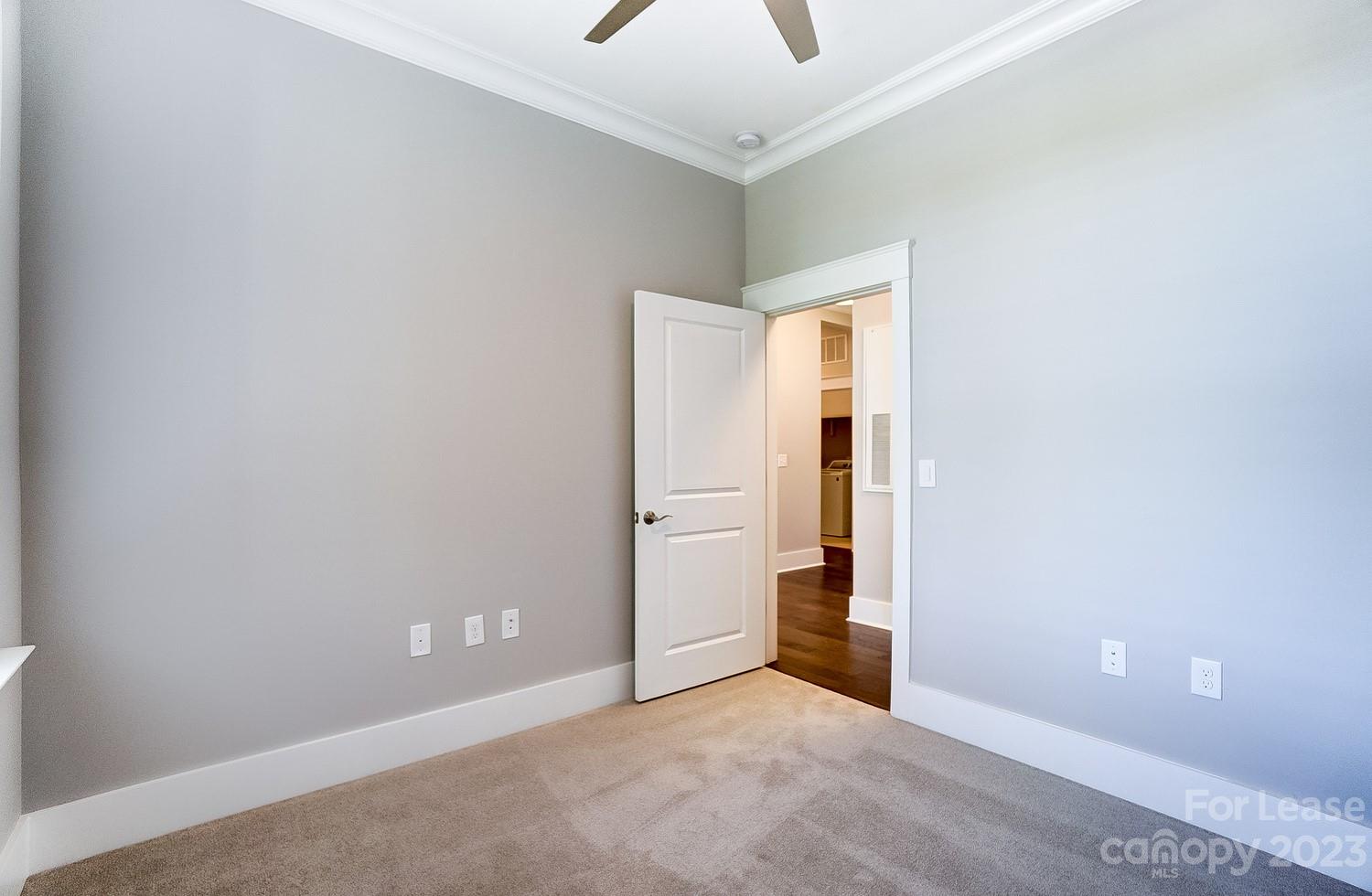 830 Providence Road, Unit 104 Charlotte, NC 28207 - Photo 17 of 21 an empty room with closet and windows