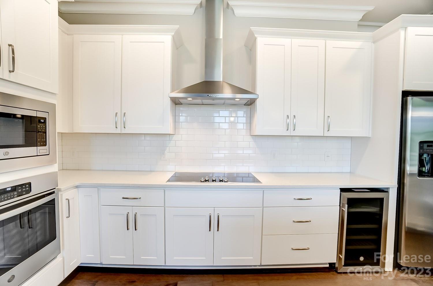 830 Providence Road, Unit 104 Charlotte, NC 28207 - Photo 7 of 21 a kitchen with white cabinets and white appliances
