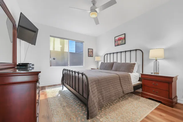 a bedroom with a bed and a flat screen tv