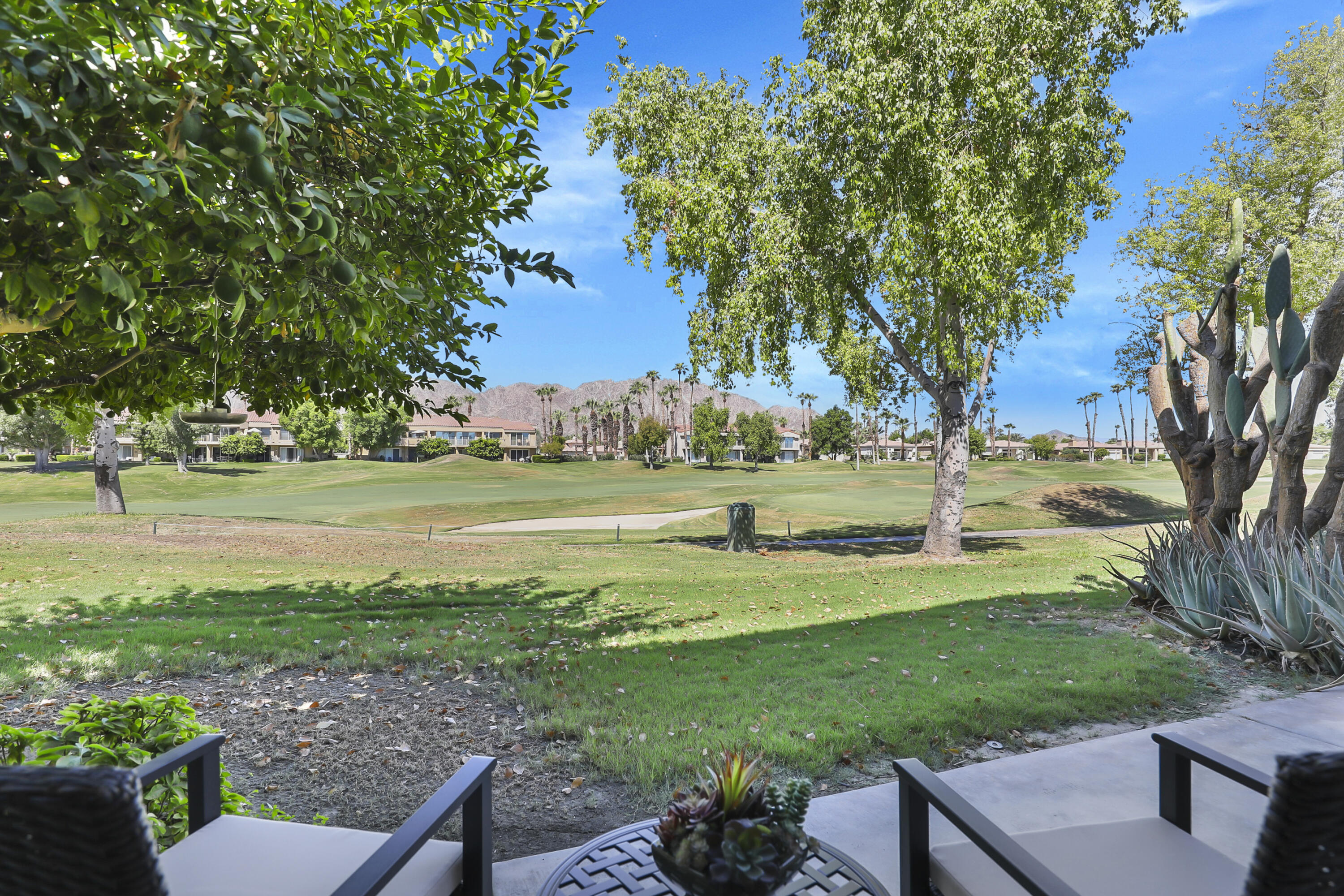 55359 Winged Foot La Quinta, CA 92253 - Photo 3 of 22 a view of a golf course with a bench