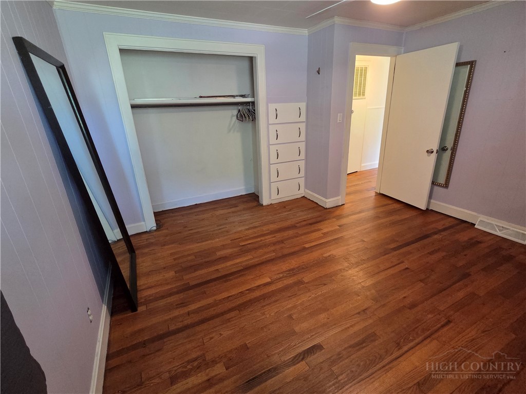 145 Black Oak Ridge Road Taylorsville, NC 28681 - Photo 19 of 39 an empty room with wooden floor and closet