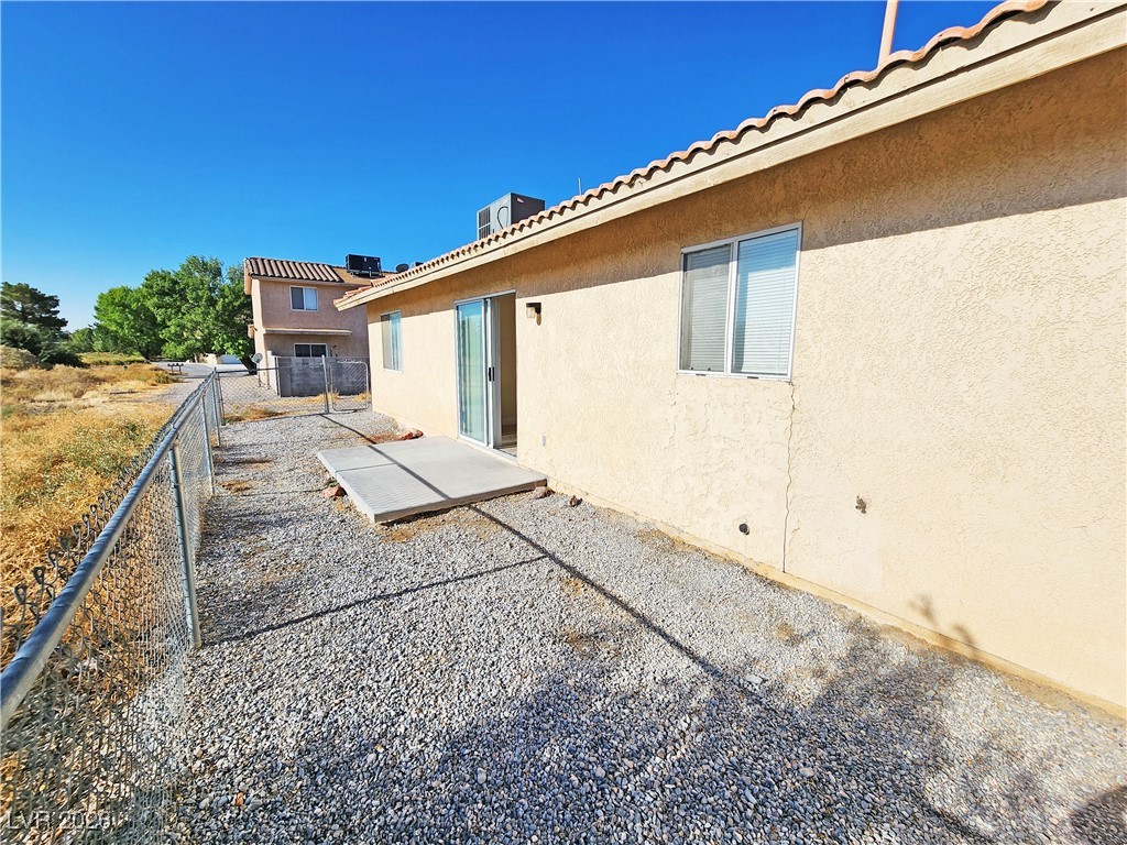 1081 Marne Court, Unit C Pahrump, NV 89048 - Photo 21 of 22 Back of house featuring stucco siding and a patio area
