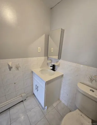 a bathroom with a sink toilet and mirror