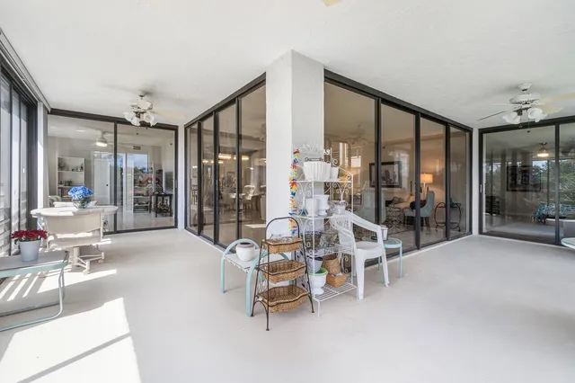 a building outdoor space with seating area and glass door