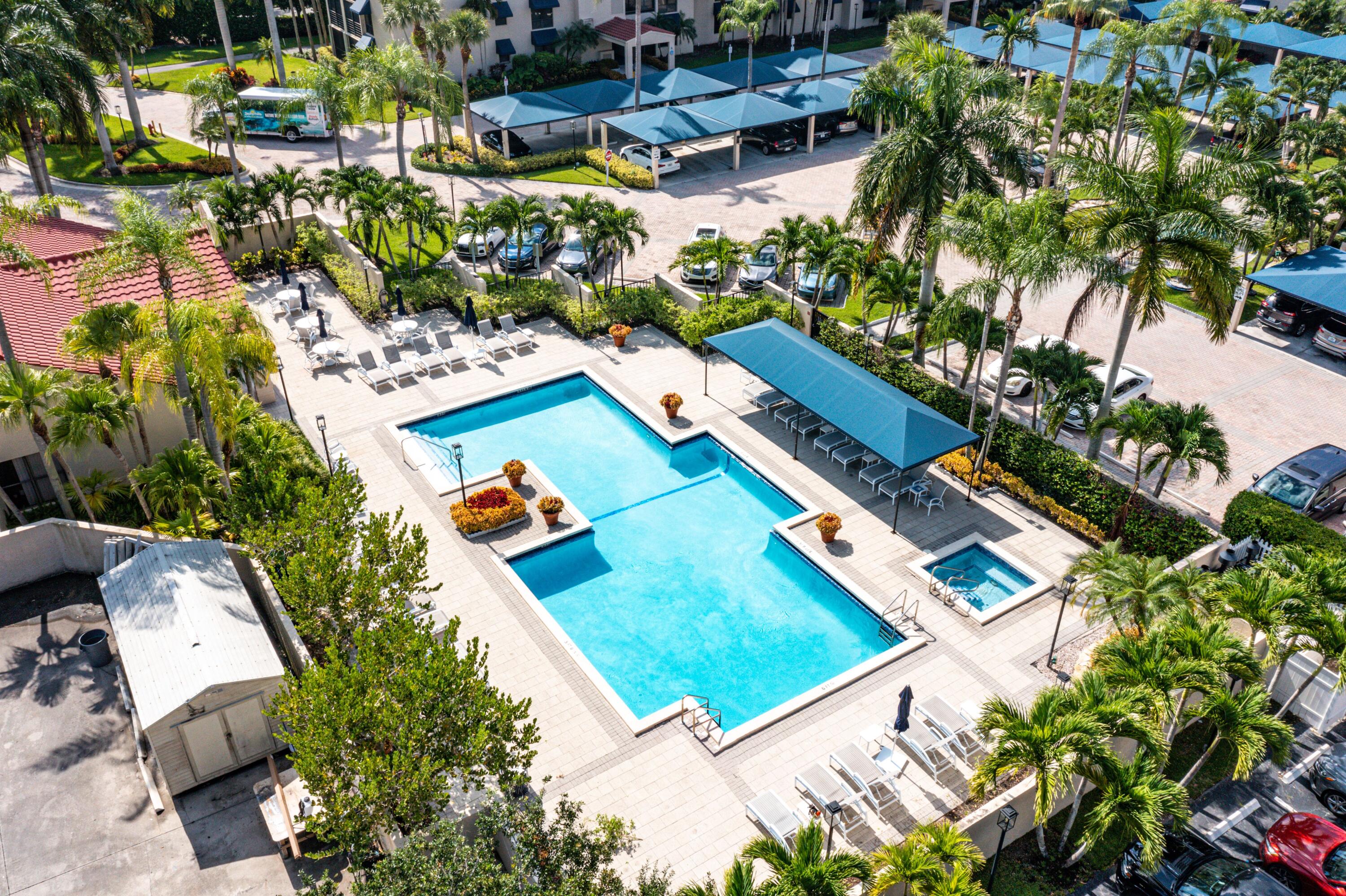 7572 Regency Lake Drive, Unit 401 Boca Raton, FL 33433 - Photo 25 of 28 an aerial view of a tennis ground and a large tree