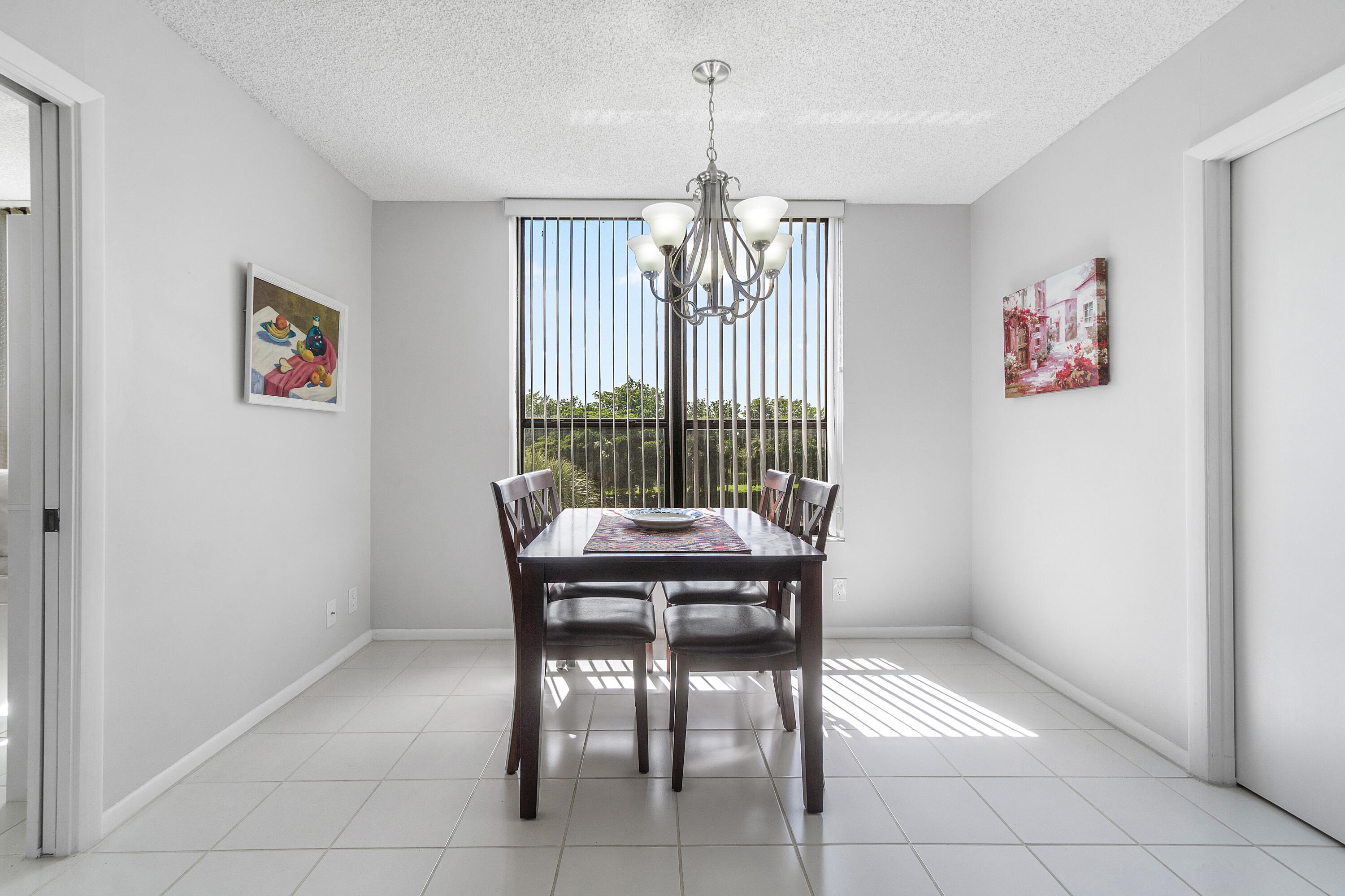 7572 Regency Lake Drive, Unit 401 Boca Raton, FL 33433 - Photo 9 of 28 a view of a dining room with furniture window and chandelier