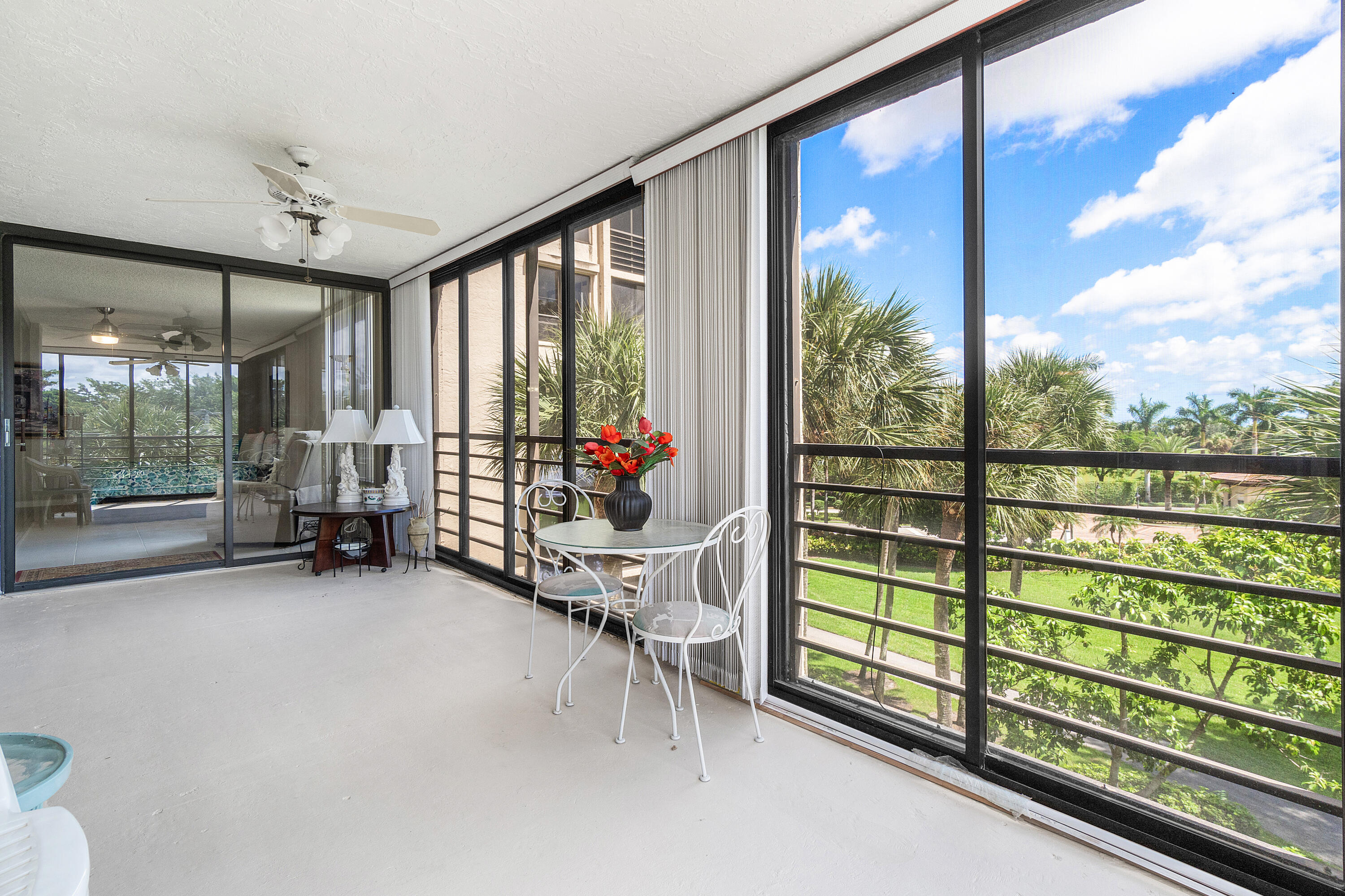 7572 Regency Lake Drive, Unit 401 Boca Raton, FL 33433 - Photo 10 of 28 a view of a porch with furniture and a gate