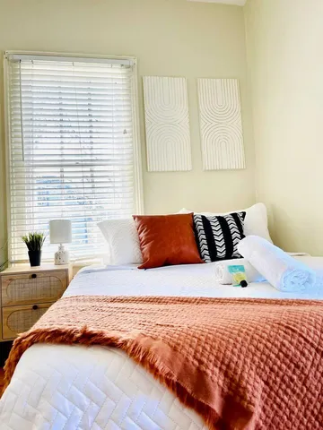 a bedroom with a bed and a window