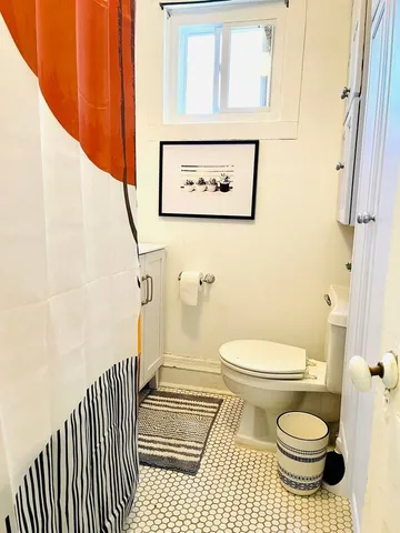 a bathroom with a toilet and a shower
