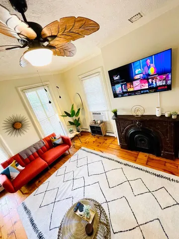 a bedroom with a bed and painting on the wall