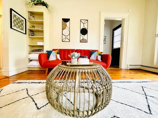 a bedroom with a bed and painting on the wall