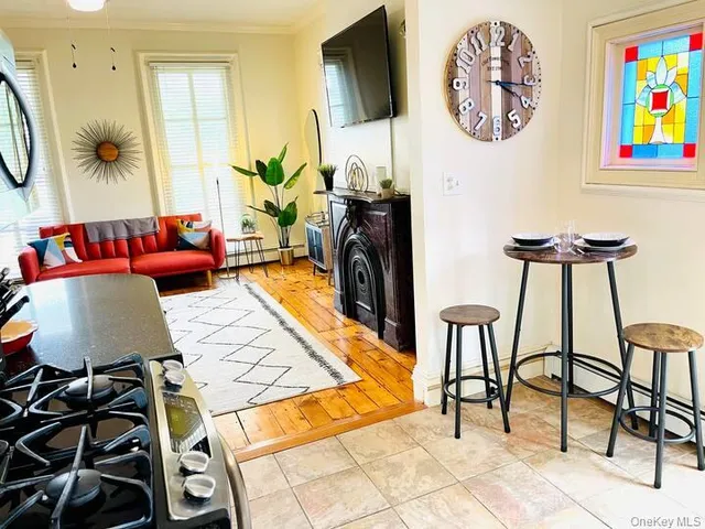 a living room with furniture a rug and a wall painting