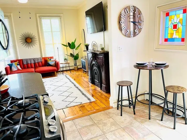 a living room with furniture a rug and a wall painting
