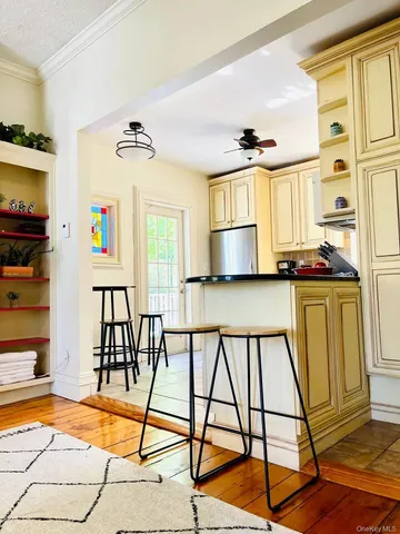 a view of a livingroom with furniture hardwood floor and a ceiling fan