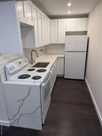 a kitchen with a sink a refrigerator a washer and dryer