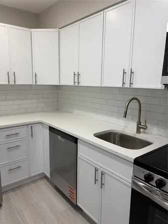 a kitchen with a sink and cabinets