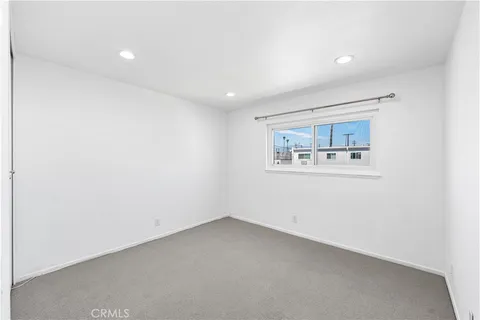 an empty room with a painting on the wall