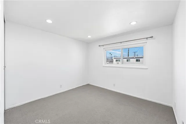an empty room with a painting on the wall