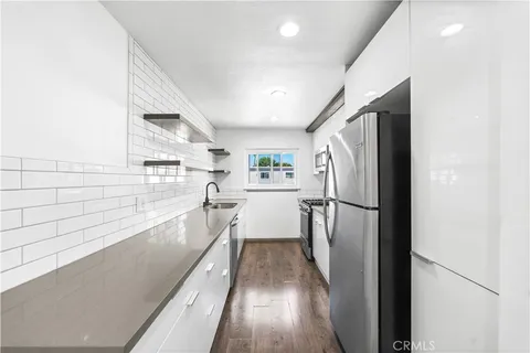 a kitchen with stainless steel appliances a refrigerator and a stove
