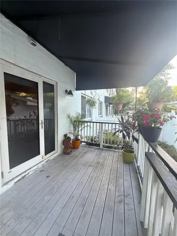 a view of a balcony with wooden floor