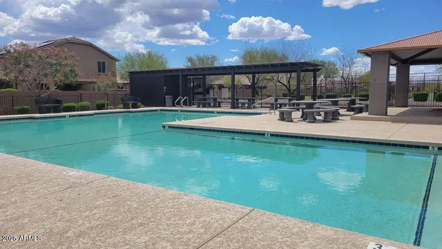 a view of a swimming pool with outdoor seating