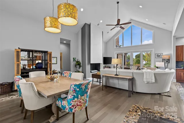 a living room with kitchen island furniture and a chandelier