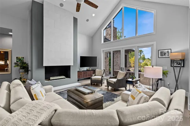 a living room with furniture a fireplace and a flat screen tv