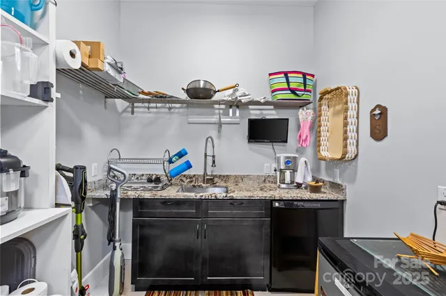 a utility room with sink dryer and washer