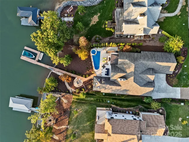 an aerial view of a house with outdoor space swimming pool
