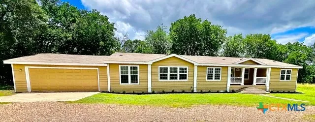 a front view of a house with a yard table and chairs