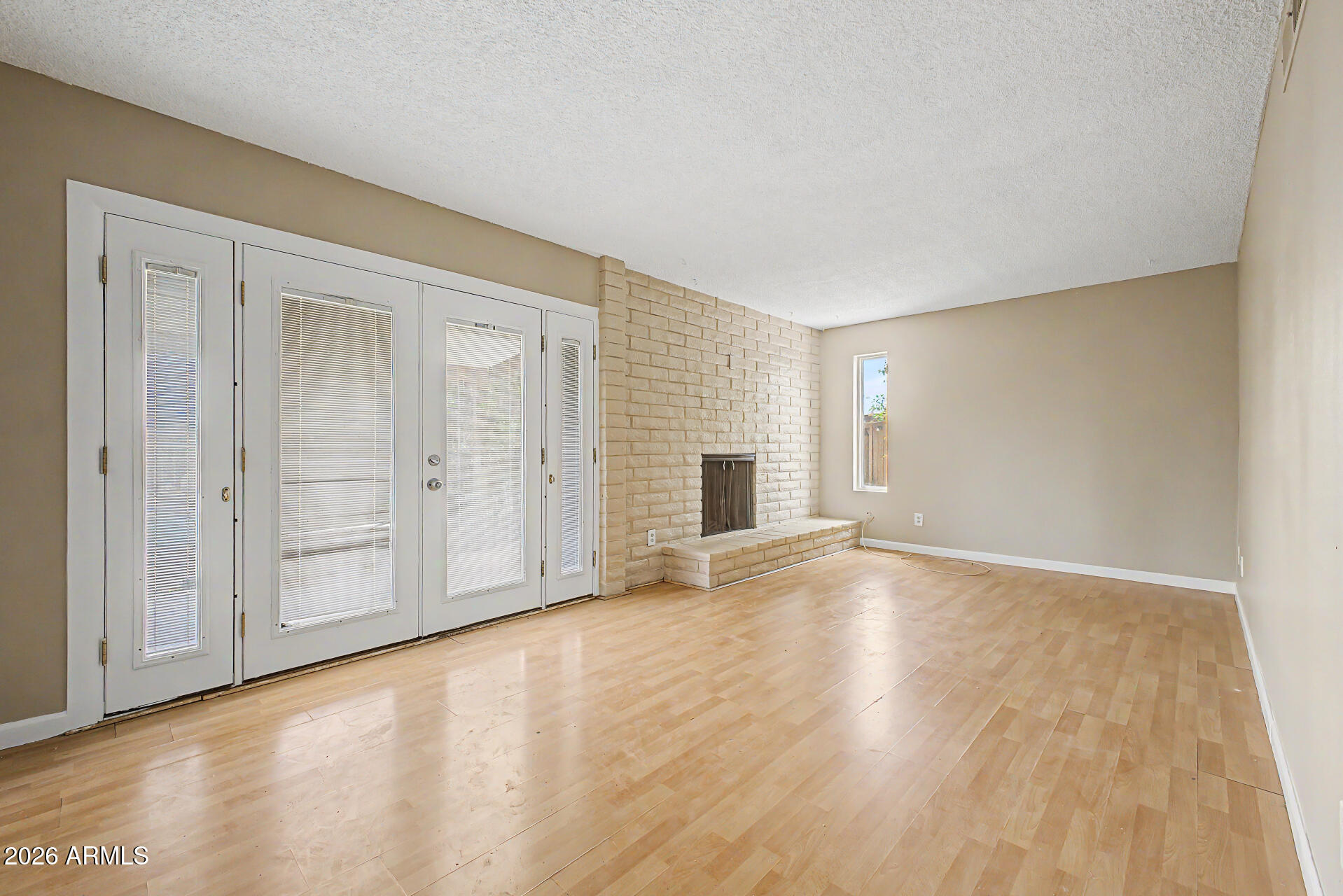 4007 West Mountain View Road Phoenix, AZ 85051 - Photo 10 of 31 a view of an empty room with wooden floor and window
