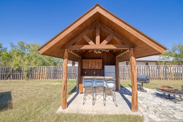 a view of patio with a table and chairs under an umbrella