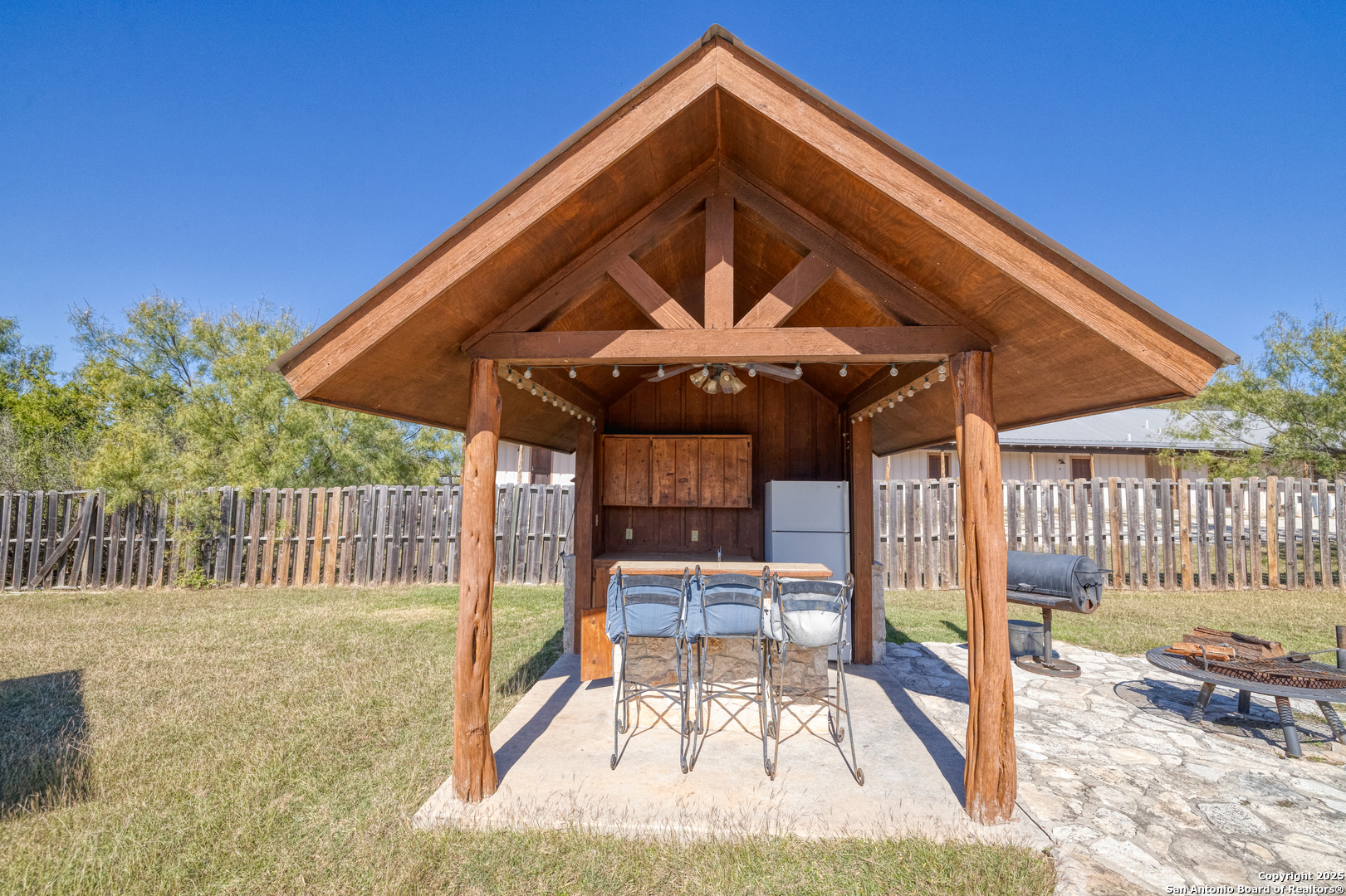 38 Mountain Laurel Lane Concan, TX 78838 - Photo 13 of 48 a view of patio with a table and chairs under an umbrella