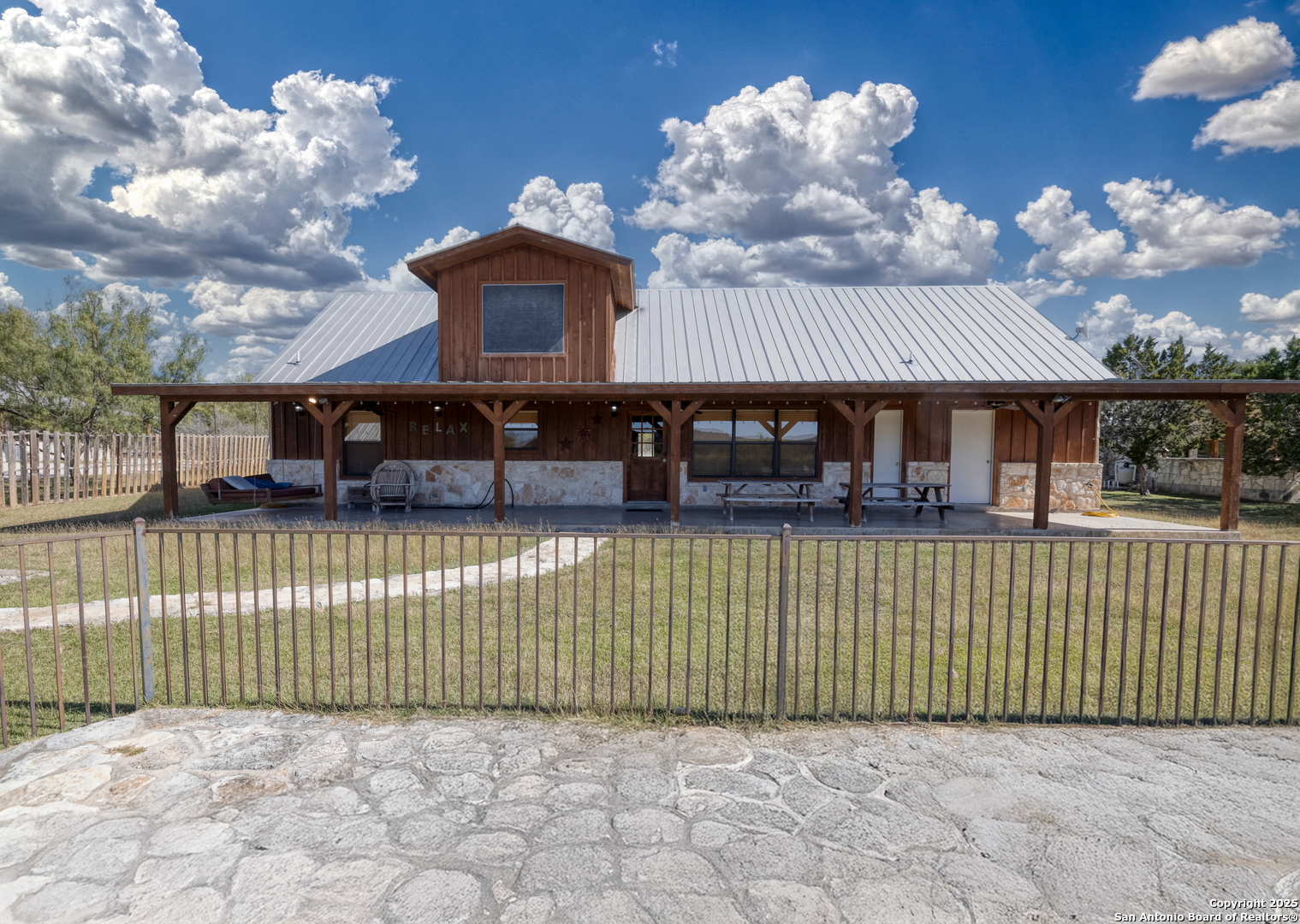 38 Mountain Laurel Lane Concan, TX 78838 - Photo 15 of 48 a front view of a house with a garden
