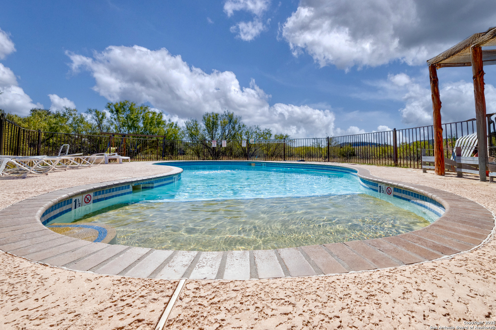 38 Mountain Laurel Lane Concan, TX 78838 - Photo 16 of 48 a view of a swimming pool with an outdoor space