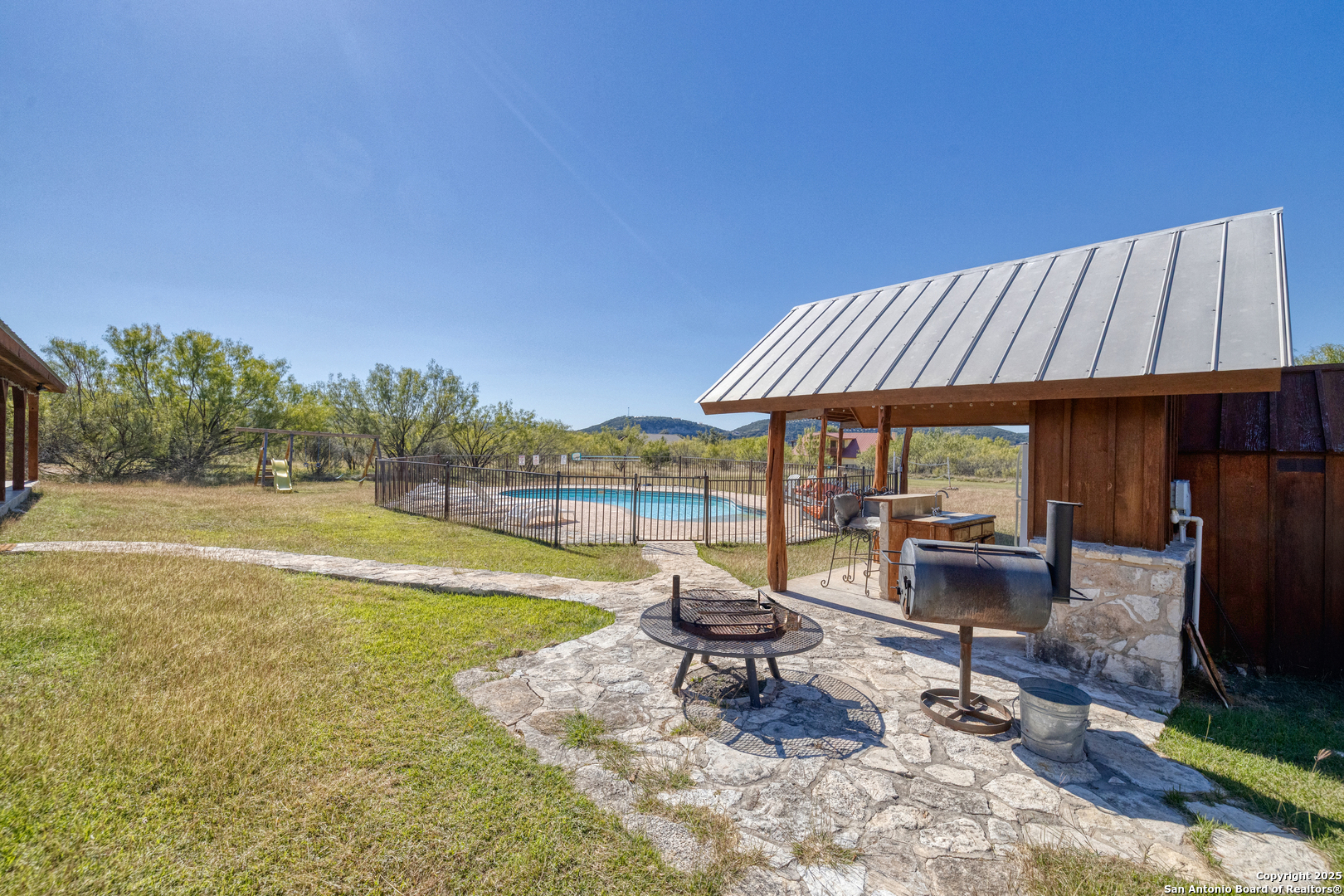 38 Mountain Laurel Lane Concan, TX 78838 - Photo 19 of 48 a view of a swimming pool with lounge chairs in patio