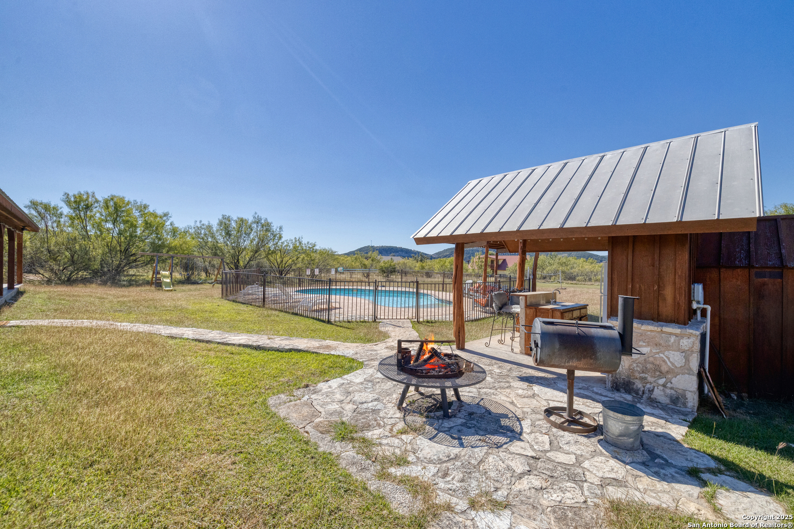 38 Mountain Laurel Lane Concan, TX 78838 - Photo 20 of 48 a view of a house with swimming pool and sitting area